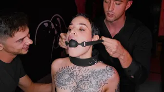 Tattooed Submissive Gagged and Dominated by Two Men in Intense BDSM Scene