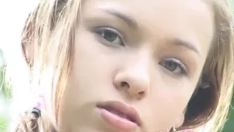 Blonde teen teases her tight pussy in a hot outdoor solo scene