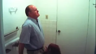 Brunette redhead gives a scandalous blowjob in the office bathroom